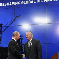 Vladimir Putin embraces his business partner, ExxonMobil chief Rex Tillerson